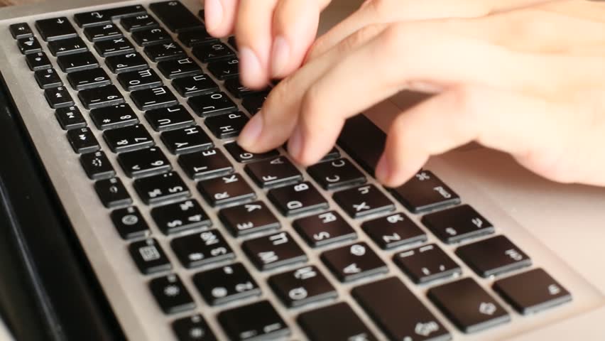 Hands typing text on a laptop keyboard (HD)