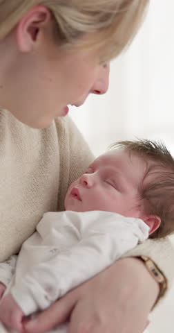 Family, kiss and a mama with a baby for sleep in the bedroom of their home together for love or care. Dreaming, nap or tired with a single mom and newborn infant in an apartment to rest for growth