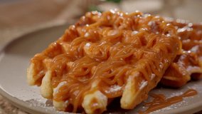 Belgian waffles decorated with caramel and raspberry sauce. Sweet dessert concept. - Powered by Shutterstock - Get 15% off with code: PIKWIZARD15