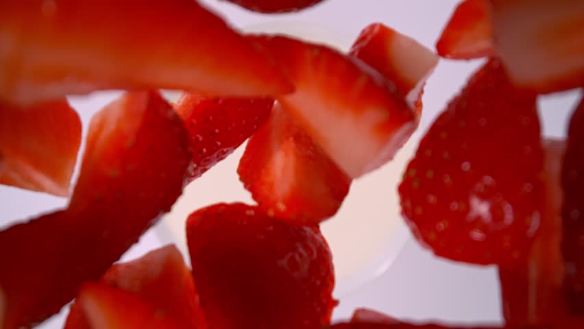 Super Slow Motion Shot of Fresh Strawberries Followed by Camera Falling into Cream at 1000fps.