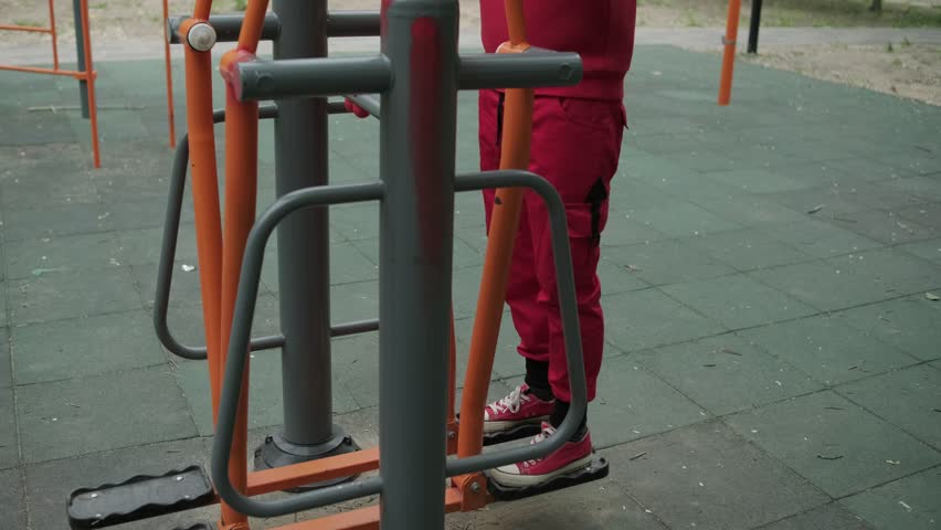 Male Athlete Exercises on Street Simulator in Park During Daytime