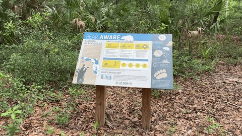 Gainesville, Florida, USA - 05 13 2024: Bear danger sign at Paynes Prairie Preserve near Gainesville Florida, bear attackt instructions, Florida wildlife and nature, central Florida Szerkesztői stockvideó
