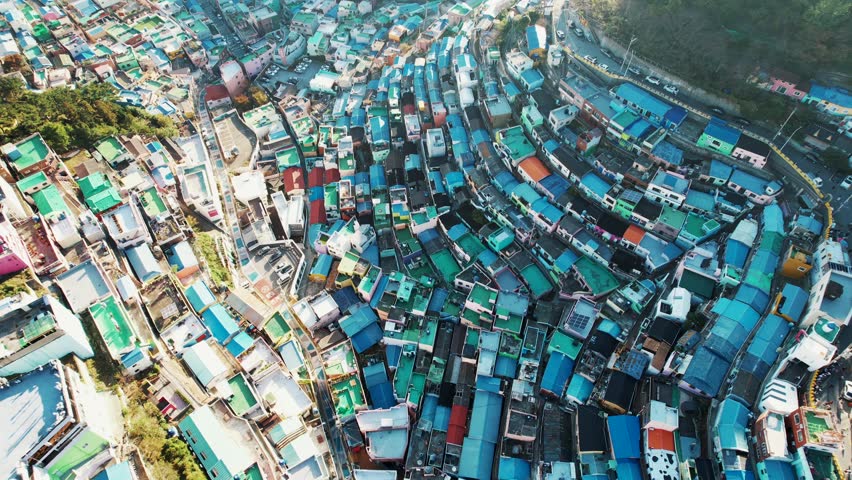The aerial view of Gamcheon Culture Village in Busan, Korea, showcasing a vibrant mosaic of densely packed colorful houses and winding streets.