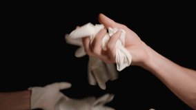 Hands in Latex Gloves Toss Many White Gloves Upward on a Black Background. One Glove Is Caught. Slow Motion. - Powered by Shutterstock - Get 15% off with code: PIKWIZARD15