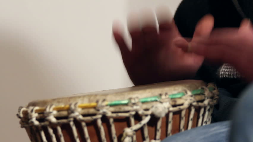 Artist playing tambourine, close up
