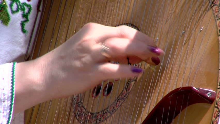 Artist playing bandura, close up