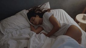 A woman sleeps peacefully in her bed at night, illustrating rest, relaxation, and a tranquil sleep environment. - Powered by Shutterstock - Get 15% off with code: PIKWIZARD15