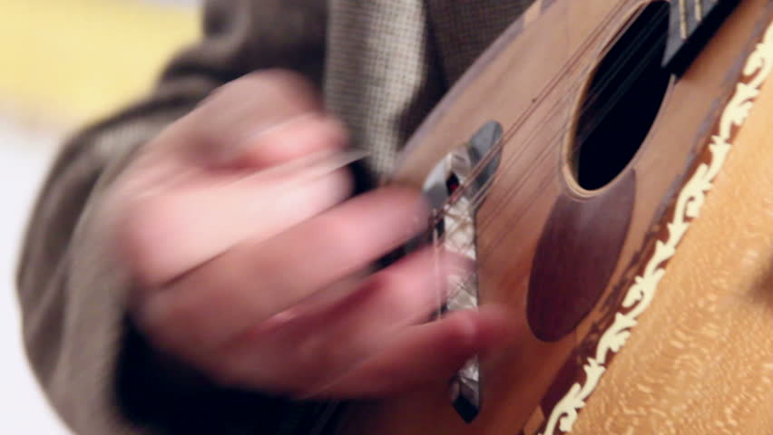 Artist playing mandolin, close up
