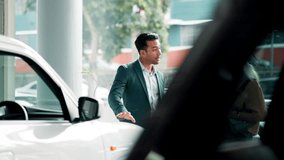 Woman, man and tablet in car dealership for sales, negotiation or consulting in vehicle finance. Conversation, salesman and customer shopping in transport showroom with digital app for auto insurance - Powered by Shutterstock - Get 15% off with code: PIKWIZARD15