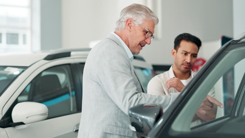 Man, dealership and car to buy, salesperson and talking for choice, purchase and customer with smile. Shop, transportation and vehicle for travel, conversation and discussion in store of New York