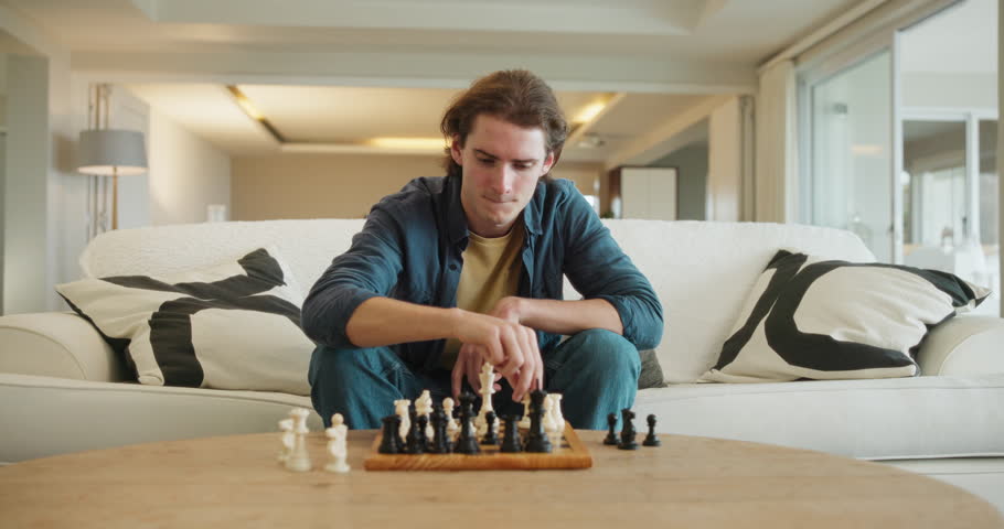 Man, chess and game in home on sofa with strategy, solution or problem solving in contest in living room. Elderly person, toys and board with idea for king, queen and knight with challenge in lounge