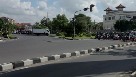 BALI - JANUARY 29: Tmelapse of traffic at Kuta intersection on January 29, 2012 in Bali, Indonesia. With the rise in population from 800.000 to 3.5 million, road development has had to follow suit.