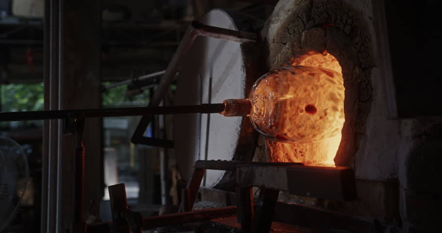 Glass Vase Reheating in Furnace at Artisan Glassblowing Workshop