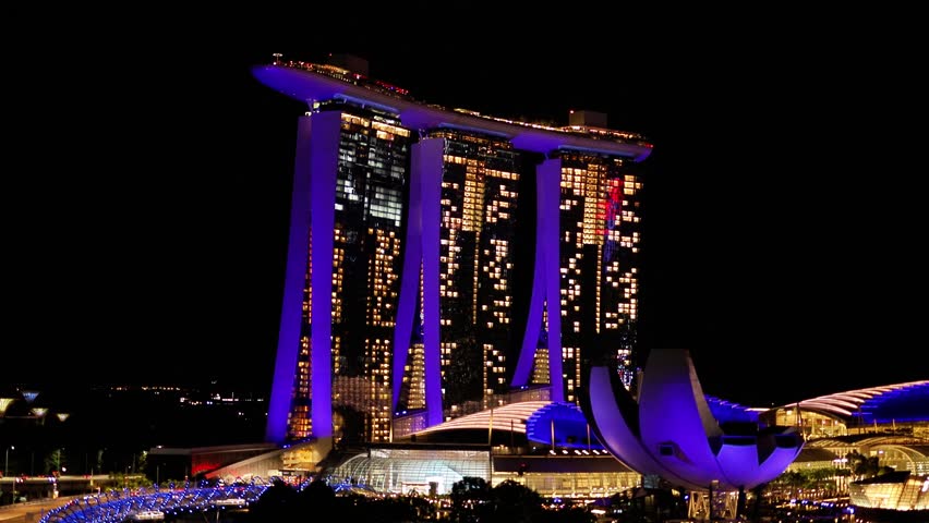 Laser lighting show over Singapore landmarks and tourist attraction. Colorful cityscape concept