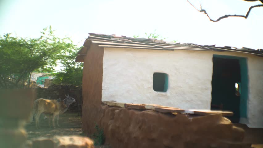 Pan shot of old colorful tribal huts in a rural village of madhya pradesh india