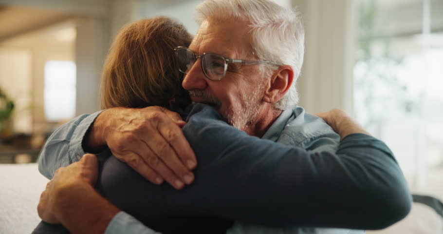 Senior father, son and hug on couch for support, love and happy bonding together in home. Relax, man and adult child embrace on sofa with respect, care or comfort on weekend in living room with smile