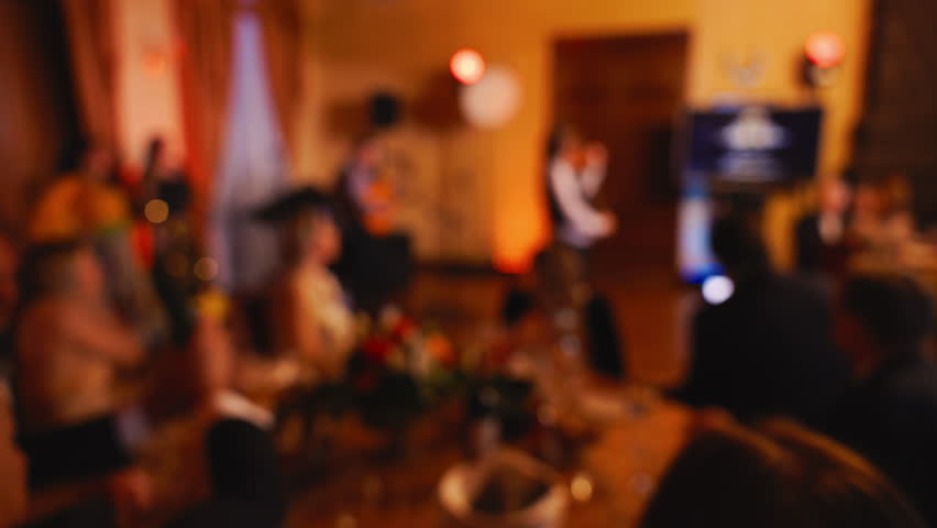 Experience an elegant dinner party in soft focus slow motion, with warm ambience and festive atmosphere