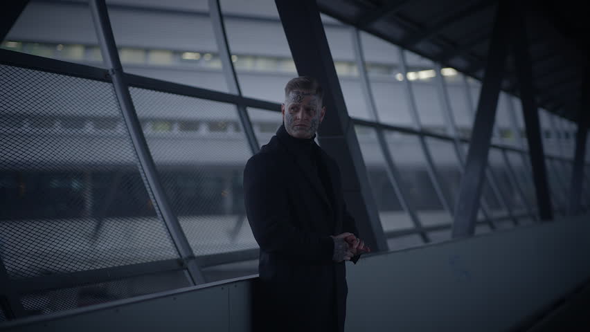 Unconventional Young Man Covered in Tattoos and Dark Black Clothes 