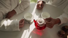 Man pours tea into woman cup at table closeup. Loving boyfriend takes care of girlfriend sharing delicious drink in morning. Romantic relationship joy - Powered by Shutterstock - Get 15% off with code: PIKWIZARD15
