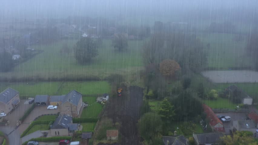 Aerial footage of the British village of Little Ribston which is a civil parish in the Harrogate district of North Yorkshire in Leeds showing the drone flying through rain clouds in the winter