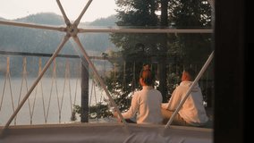 Couple immerses in meditation on glamping site. Husband and wife exude palpable sense of harmony finding solace within eco-friendly haven of retreat - Powered by Shutterstock - Get 15% off with code: PIKWIZARD15