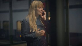 Blond Woman Talking Angry on Mobile Phone at Trainstation Arguing - Powered by Shutterstock - Get 15% off with code: PIKWIZARD15