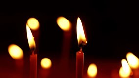 A lot of burning candles in the temple. The concept of religion, prayer and God. Close-up of the flame burning on the candle with isolated on a black background. Memorial Day with in the church. - Powered by Shutterstock - Get 15% off with code: PIKWIZARD15