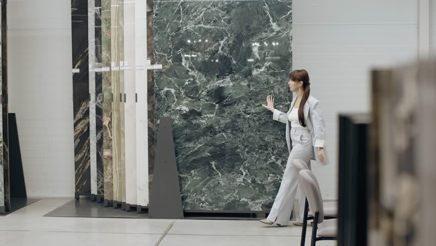 Tile salon designer browsing marble samples