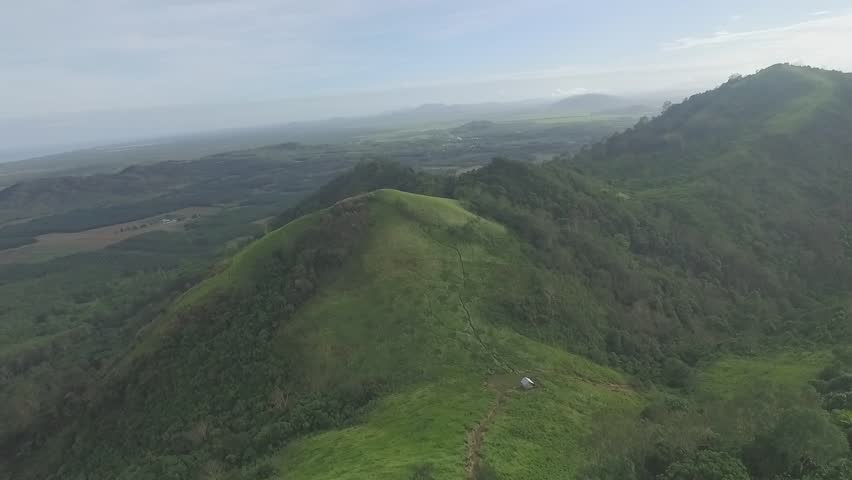 From the peaks of the towering mountains, stunning views stretch out before the eyes. In the distance, the green valley spread out like a perfectly spread natural carpet, filled with towering trees an