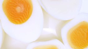 In this close-up, halved boiled eggs showcase vibrant yellow yolks nestled within pristine, smooth egg whites. The creamy texture of the yolks contrasts with the firmness of the whites.
 - Powered by Shutterstock - Get 15% off with code: PIKWIZARD15