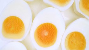 Zoom in, the boiled eggs lay exposed, their halves revealing rich, yellow yolks nestled within pristine white shells. A touch reveals their firm texture, a testament to their hard-boiled perfection.
 - Powered by Shutterstock - Get 15% off with code: PIKWIZARD15