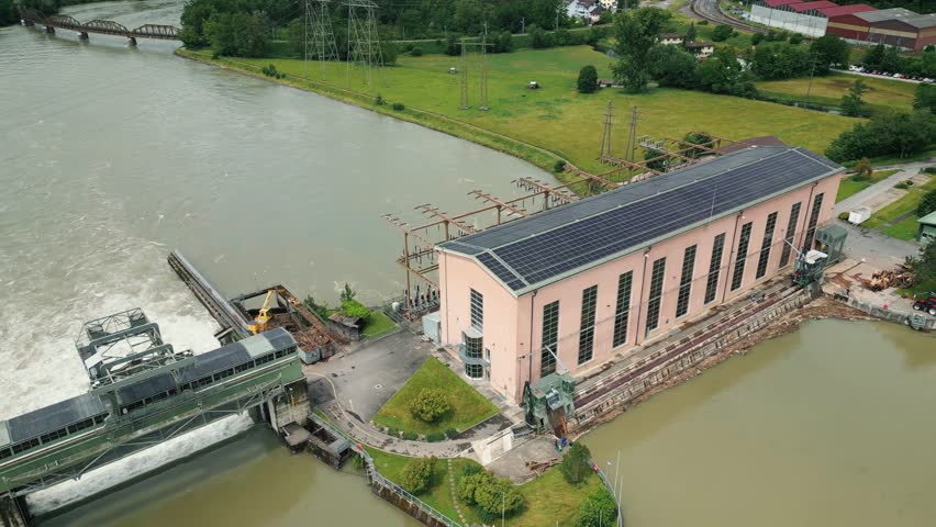 Hydroelectric water power station releasing huge amount of water. Overflowing river Rhine with dirty polluted water after flood, Waldshut-Tiengen, Germany