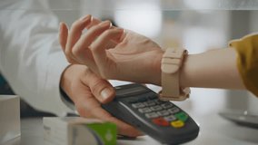 Medical. A drug consultant accepts payment using a smartwatch at pharmacy. An employee controls the payment process with a smart watch, online payment provides advice on health issues, pharmaceuticals - Powered by Shutterstock - Get 15% off with code: PIKWIZARD15