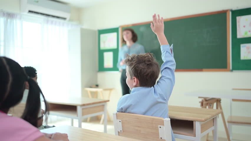 Teacher and students, Learn and study in a classroom of school where youngsters sit and listen attentively. - Powered by Shutterstock - Get 15% off with code: PIKWIZARD15