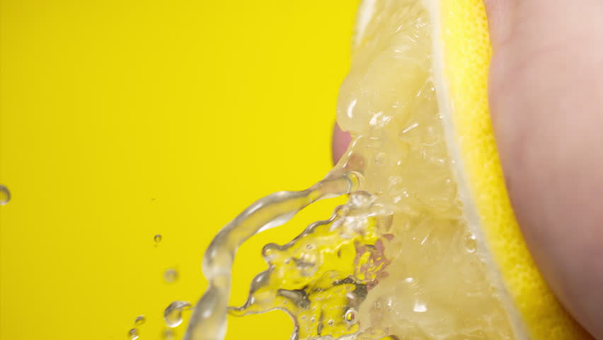 Squeezing out fresh Lemon juice drains from the pulp Super slow-mo 1000 fps