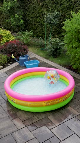 Rainstorm in backyard. Summer and swimming pool in bad weather. 