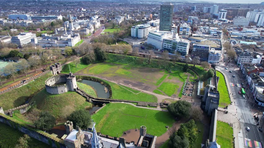 Overhead shot of old Cardiff Castle surrounded by modern buildings of the city, Wales
