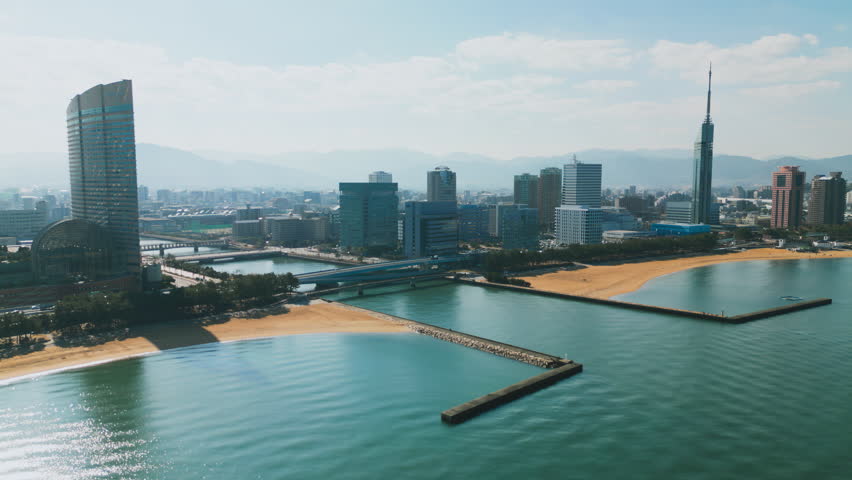Drone flight view large busy harbor with restaurants and large city with glass skyscrapers. Fukuoka, Japan