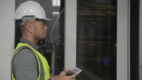 an asian man IT technician working on network Internet cables and servers and try to checklist on the clipboard to maintenance the data sharing network and all the cable, laptop, tablet, clipboard. - Powered by Shutterstock - Get 15% off with code: PIKWIZARD15