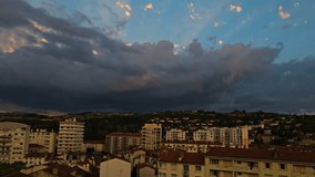 Beautiful crepuscular rays behind cloud bank over a small town; timelapse of sun rays through cumulus clouds above downtown area of French town, with hills in background; weather over buildings
 - Powered by Shutterstock - Get 15% off with code: PIKWIZARD15