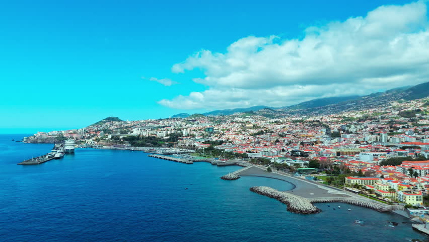 Aerial view of Funchal cityscape, Madeira capital in Portugal. City and mountains in backdrop
