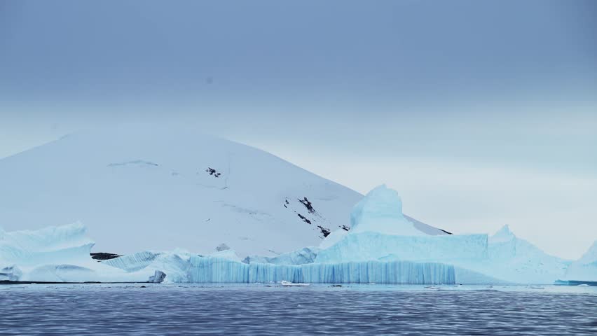 Big Iceberg in Antarctica Winter Scenery, Amazing Shape Ice Formation of Massive Large Enormous Blue Icebergs in Antarctic Peninsula Landscape Seascape with Ocean Sea Water