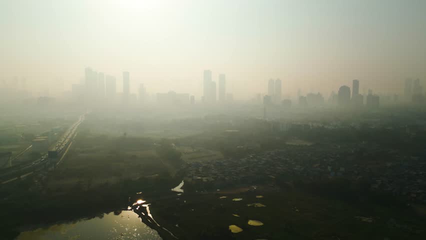Mumbai skyline covered in smog, extreme air pollution India, drone flyover aerial establishment shot