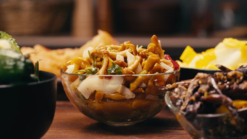 Close-up of fermented yellow honeydew mushrooms with onion in plate. Preservation of vegetables in glass jars. Fermentation preserved mushroom with spices.