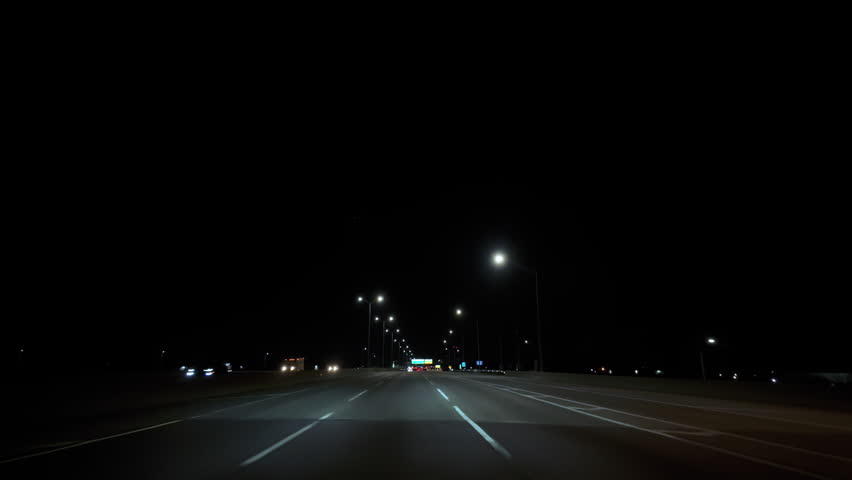 Driving in on a road at night time. POV wide view footage
