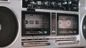 A finger presses the eject button on a vintage boombox, releasing the cassette tape and bringing a nostalgic listening session to an end. - Powered by Shutterstock - Get 15% off with code: PIKWIZARD15