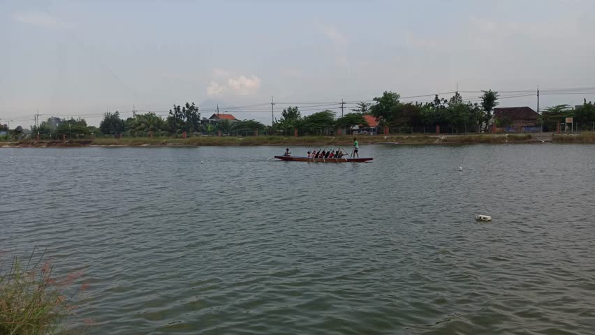 watching the athletes practice boats on the river