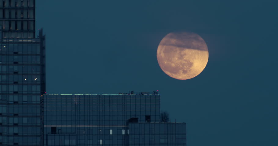 New York City High-Rise Rooftop with Full Moon Rising with Clouds Passing