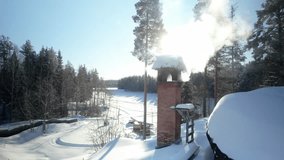 Winter retreat in Northern Sweden. Aerial drone footage reveals a charming house nestled amidst snowy surroundings, with smoke gently rising from its chimney, creating a cozy and inviting atmosphere - Powered by Shutterstock - Get 15% off with code: PIKWIZARD15
