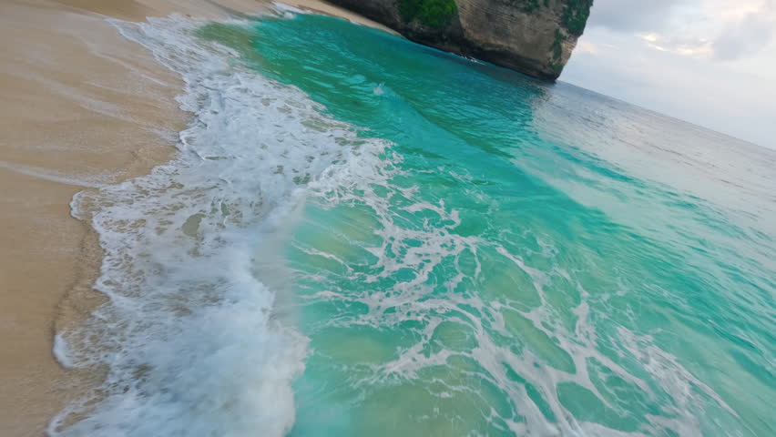 Kelingking Beach close to the waves FPV Drone